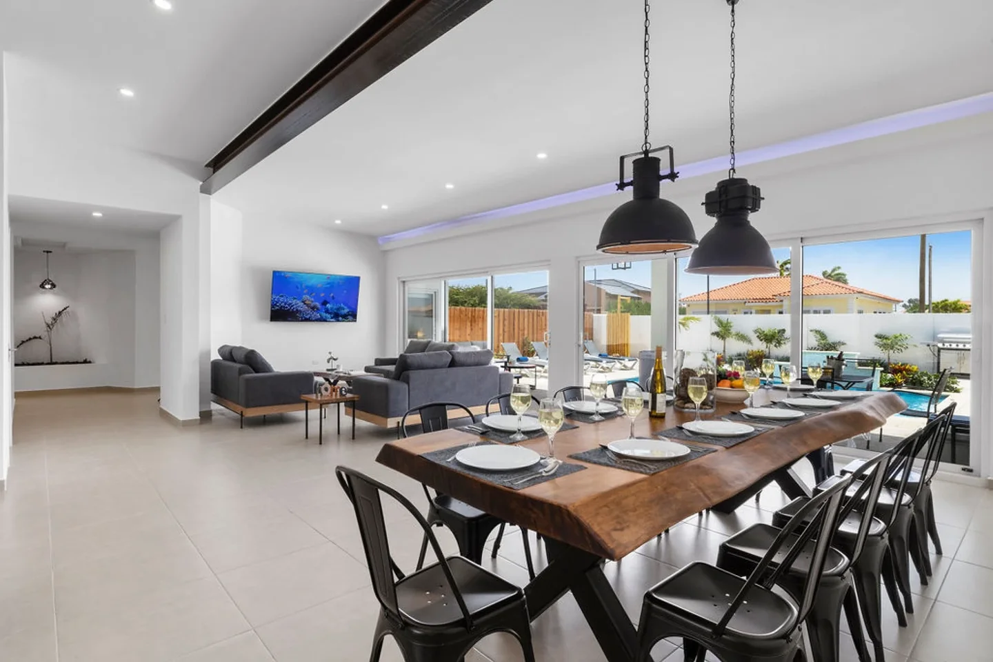 Sunlit dining room at Esmeralda 36 with a timber table and black pendants — original listing photograph